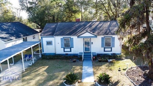 view of front of property with a front yard and a chimney