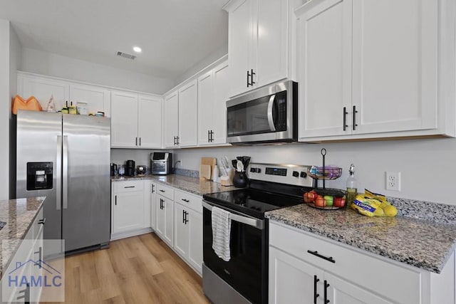 568 Abode Ave, Hinesville, GA 31313 - kitchen with stainless steel appliances, white cabinets, light wood-style flooring, and recessed lighting