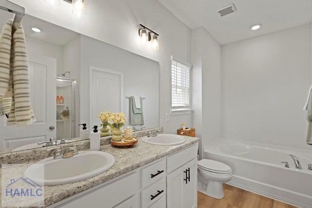 568 Abode Ave, Hinesville, GA 31313 - bathroom featuring a bath, double vanity, wood finished floors, and a shower with door