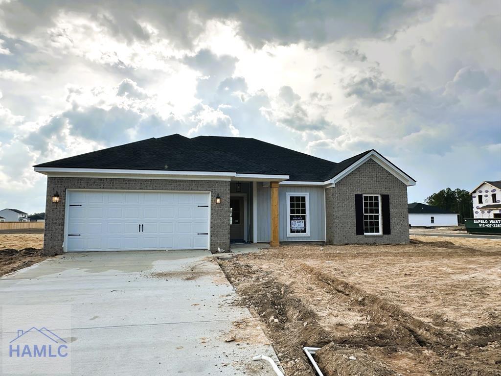 453 Lanier Rd NE, Ludowici, GA 31316 - ranch-style house with a garage, concrete driveway, and brick siding