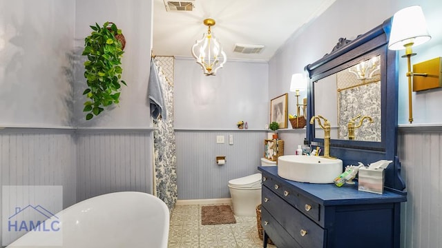 314 Twin Parks Dr, Jesup, GA 31545 - bathroom featuring vanity, wainscoting, a freestanding tub, and ornamental molding