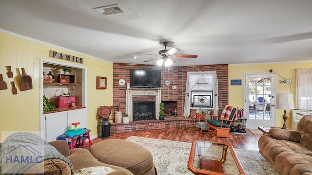 314 Twin Parks Dr, Jesup, GA 31545 - living area featuring ornamental molding, wood finished floors, ceiling fan, and a fireplace