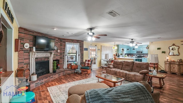 314 Twin Parks Dr, Jesup, GA 31545 - living room with a ceiling fan, wood finished floors, and a brick fireplace