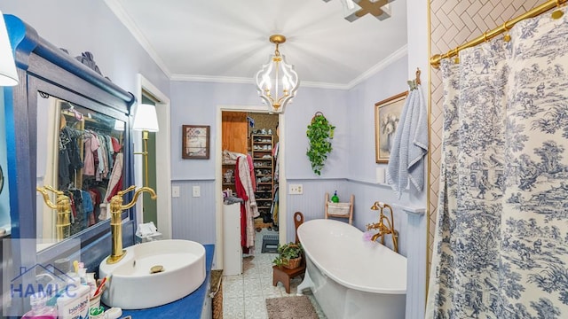 314 Twin Parks Dr, Jesup, GA 31545 - bathroom featuring a walk in closet, a chandelier, crown molding, wainscoting, and a freestanding bath