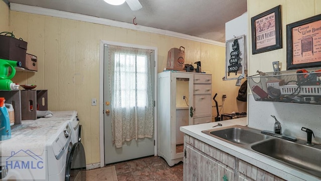 314 Twin Parks Dr, Jesup, GA 31545 - kitchen featuring washer and dryer, light countertops, ornamental molding, a ceiling fan, and wooden walls