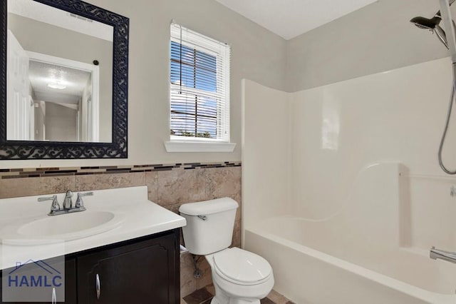 65 W Kenny Dr, Hinesville, GA 31313 - full bathroom with vanity,  shower combination, tile walls, and a wainscoted wall