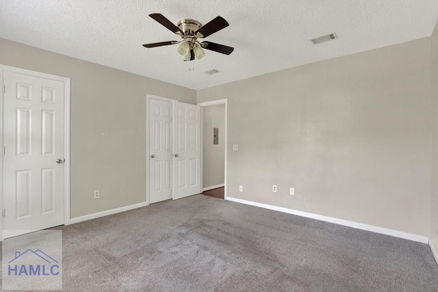 65 W Kenny Dr, Hinesville, GA 31313 - unfurnished bedroom featuring carpet floors, a textured ceiling, and a ceiling fan