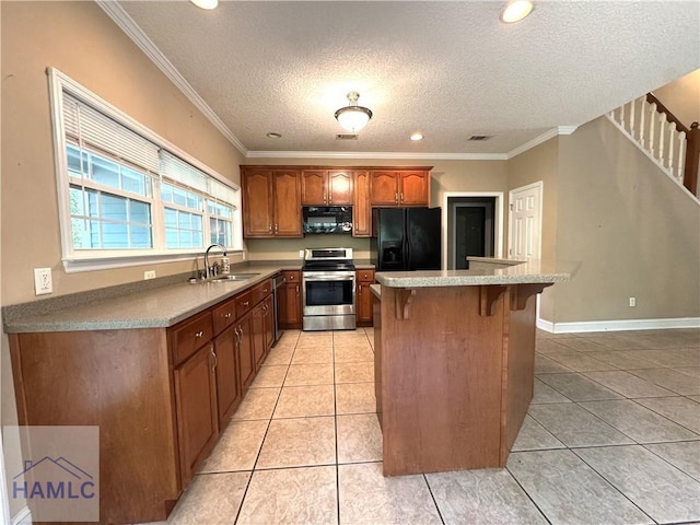 440 Arnold River Rd, Jesup, GA 31545 - kitchen with stainless steel range with electric stovetop, black fridge, a breakfast bar, crown molding, and a center island