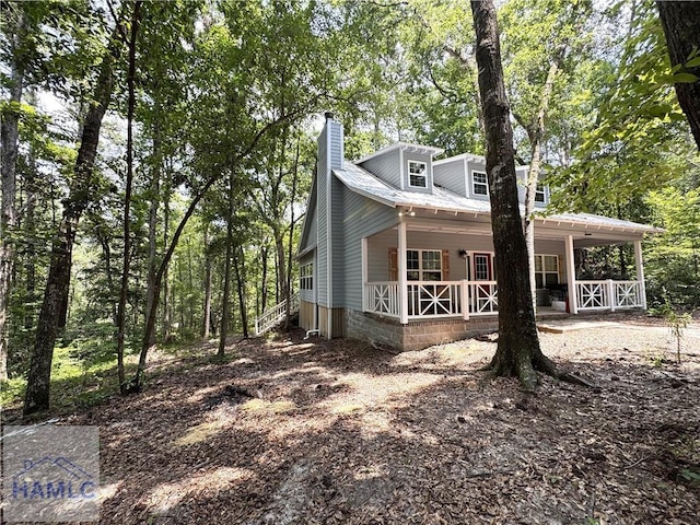 440 Arnold River Rd, Jesup, GA 31545 - view of front of house with a porch and a chimney