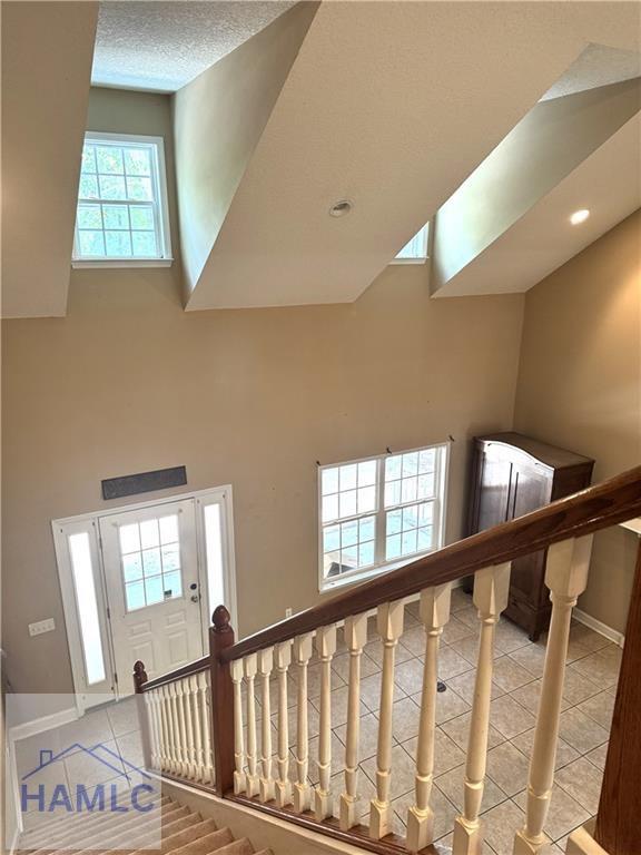 440 Arnold River Rd, Jesup, GA 31545 - staircase featuring tile patterned floors, a high ceiling, and recessed lighting