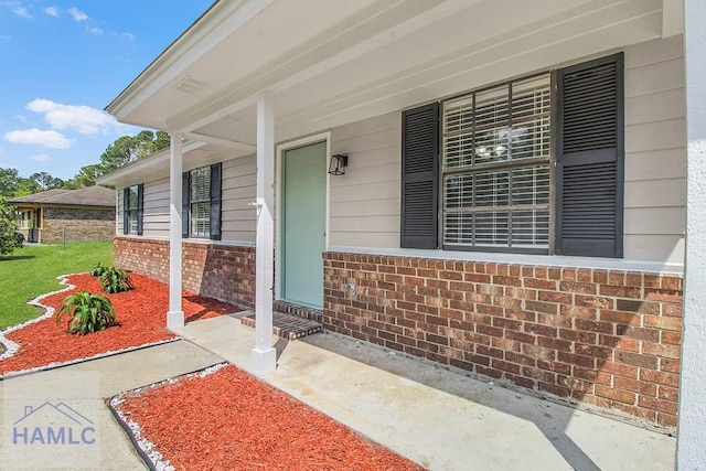 197 Sequoia Cir, Hinesville, GA 31313 - doorway to property with a porch, a yard, and brick siding