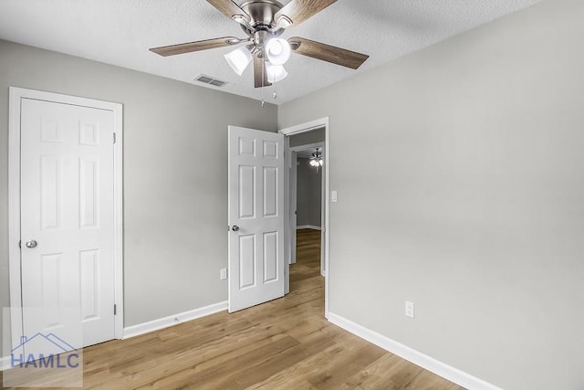 197 Sequoia Cir, Hinesville, GA 31313 - unfurnished bedroom with visible vents, baseboards, ceiling fan, light wood-type flooring, and a textured ceiling
