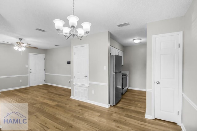 197 Sequoia Cir, Hinesville, GA 31313 - interior space with a textured ceiling, ceiling fan with notable chandelier, wood finished floors, and visible vents