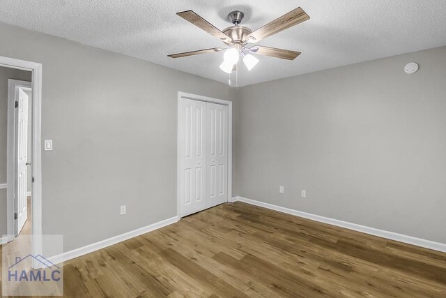 197 Sequoia Cir, Hinesville, GA 31313 - unfurnished bedroom featuring a textured ceiling, a closet, a ceiling fan, wood finished floors, and baseboards