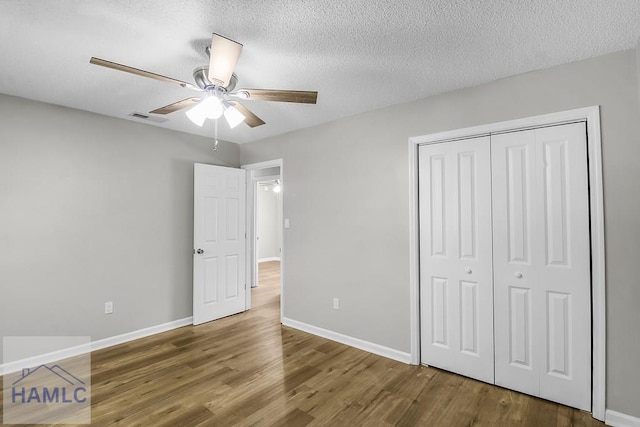 197 Sequoia Cir, Hinesville, GA 31313 - unfurnished bedroom with visible vents, a closet, wood finished floors, and a textured ceiling