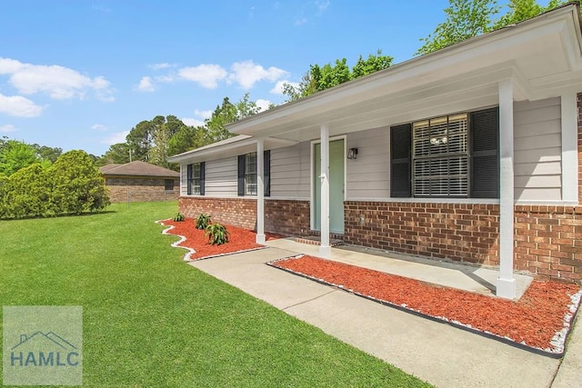 197 Sequoia Cir, Hinesville, GA 31313 - view of exterior entry with brick siding and a yard