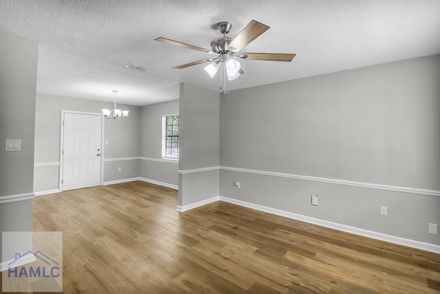 197 Sequoia Cir, Hinesville, GA 31313 - empty room with baseboards, a textured ceiling, visible vents, ceiling fan with notable chandelier, and wood finished floors