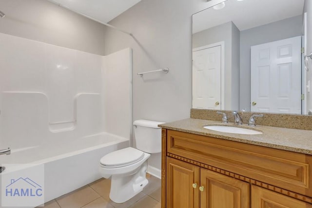 full bathroom featuring vanity, tile patterned floors, toilet, and washtub / shower combination