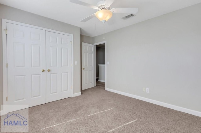 unfurnished bedroom featuring ceiling fan, carpet flooring, and a closet