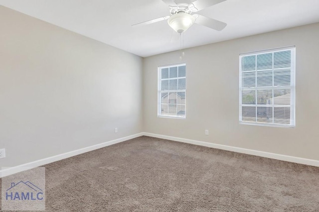 carpeted spare room featuring ceiling fan