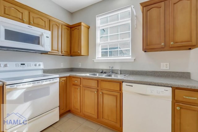 kitchen featuring white appliances, sink, and light tile patterned floors