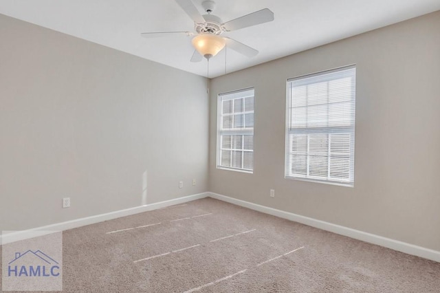 carpeted spare room with ceiling fan