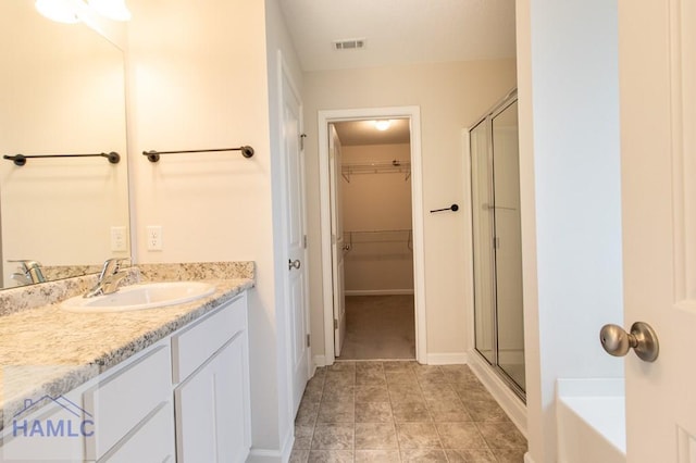 bathroom featuring separate shower and tub and vanity