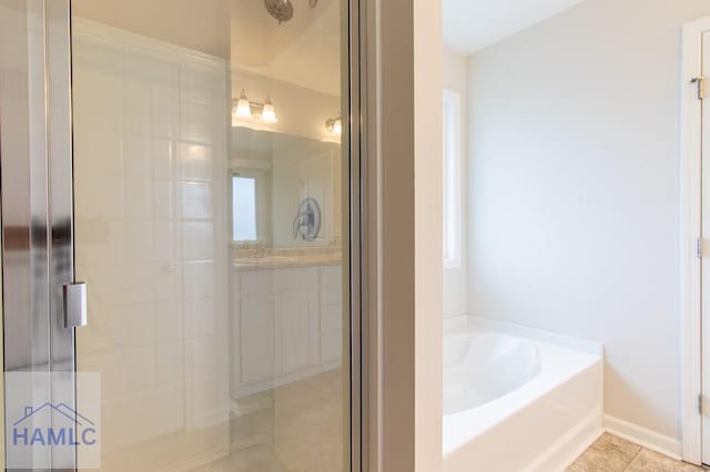 bathroom with tile patterned flooring and independent shower and bath