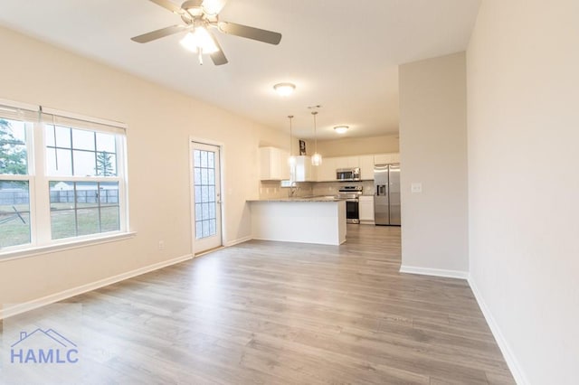 interior space featuring ceiling fan, light hardwood / wood-style flooring, and sink