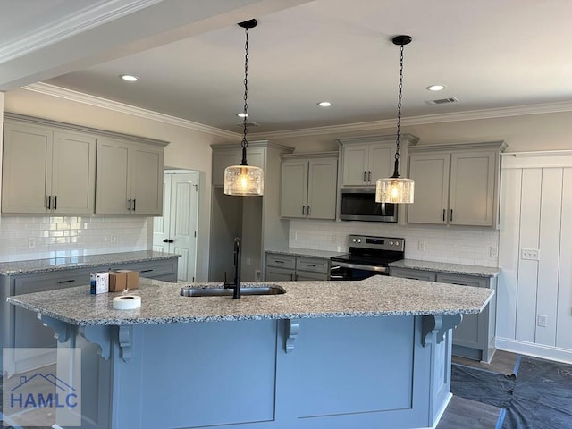 kitchen with sink, a kitchen breakfast bar, backsplash, pendant lighting, and appliances with stainless steel finishes