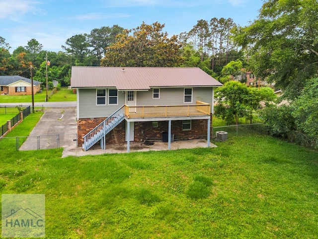 654 Mcdowell Rd, Hinesville, GA 31313 - rear view of house with stairway, central AC, metal roof, and a deck