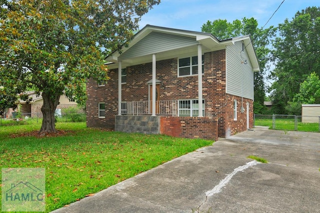 654 Mcdowell Rd, Hinesville, GA 31313 - view of front of home with covered porch, brick siding, and concrete driveway