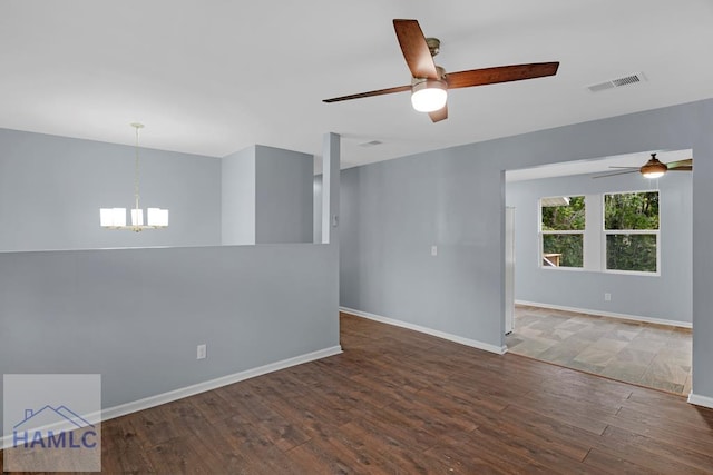 654 Mcdowell Rd, Hinesville, GA 31313 - spare room featuring ceiling fan, a chandelier, wood finished floors, and baseboards