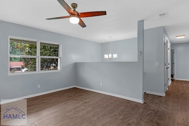 654 Mcdowell Rd, Hinesville, GA 31313 - spare room with dark wood finished floors, a chandelier, ceiling fan, and baseboards