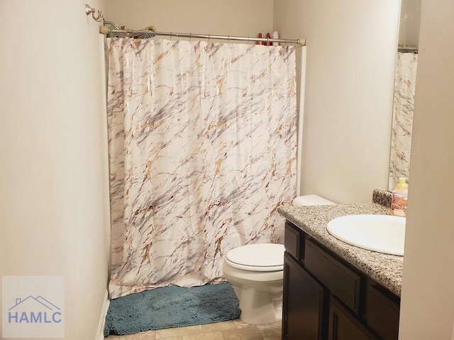 bathroom with vanity, curtained shower, and toilet