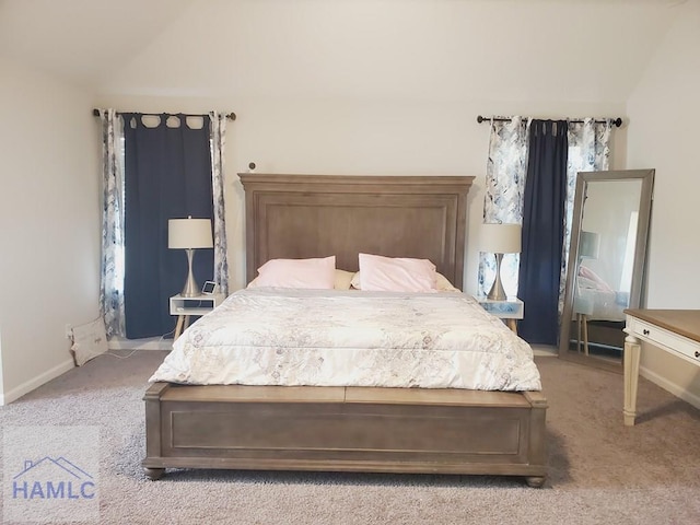 carpeted bedroom featuring vaulted ceiling