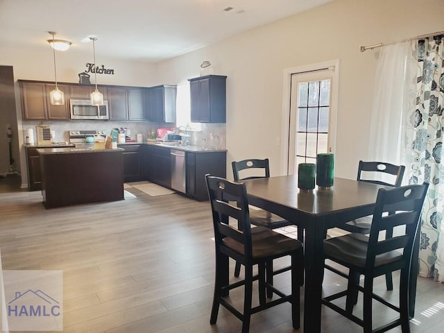 dining space featuring sink and light wood-type flooring