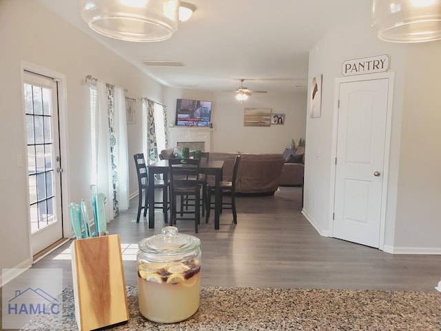 dining area featuring dark wood-type flooring and ceiling fan