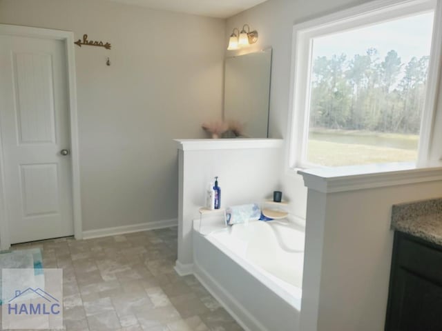 bathroom with vanity and a tub to relax in