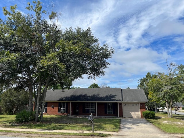 ranch-style home with a front lawn and a garage