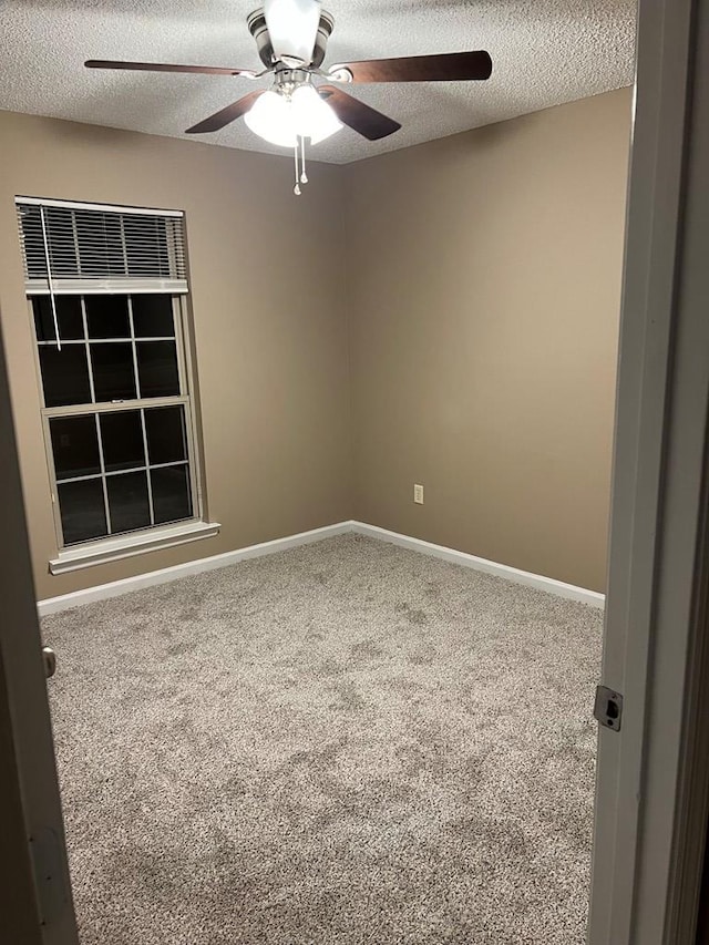 carpeted spare room featuring a textured ceiling