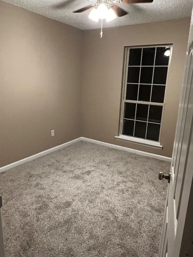 spare room featuring carpet flooring, a textured ceiling, and ceiling fan