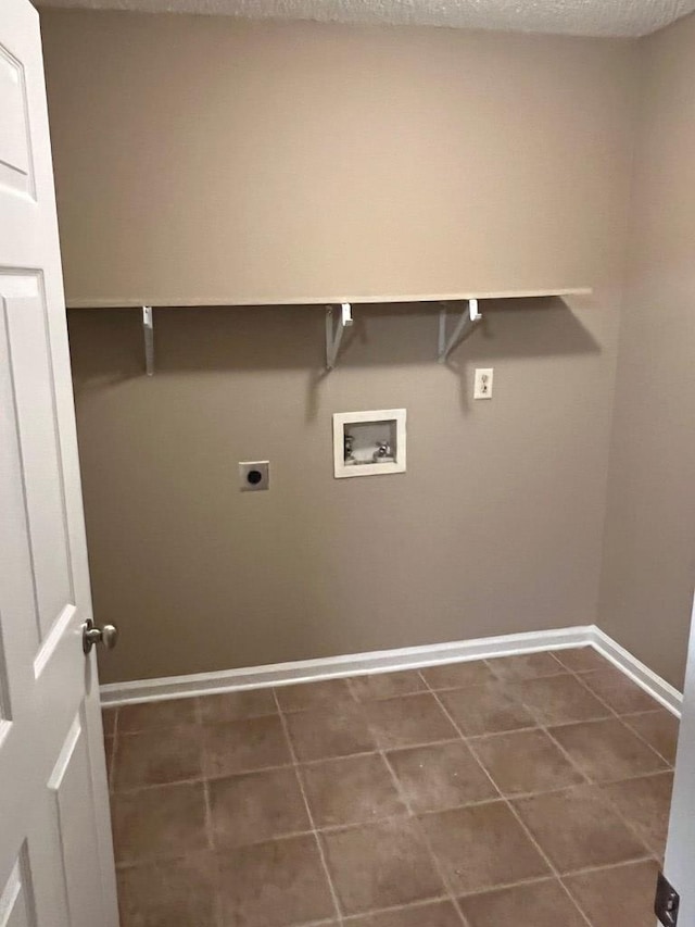 laundry room featuring washer hookup, hookup for an electric dryer, dark tile patterned floors, and a textured ceiling