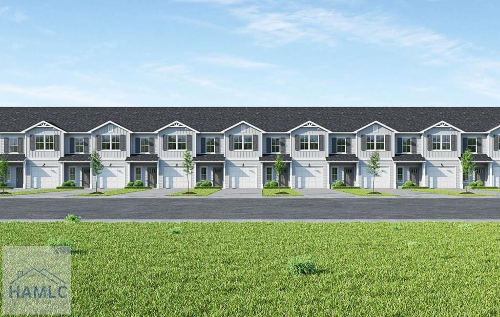 view of property featuring a garage, a front lawn, and a residential view