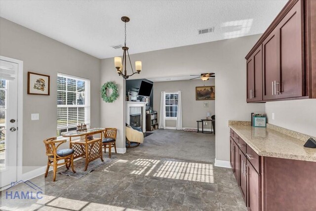 732 Waterlily Ct, Hinesville, GA 31313 - dining area with a fireplace, visible vents, a ceiling fan, and baseboards