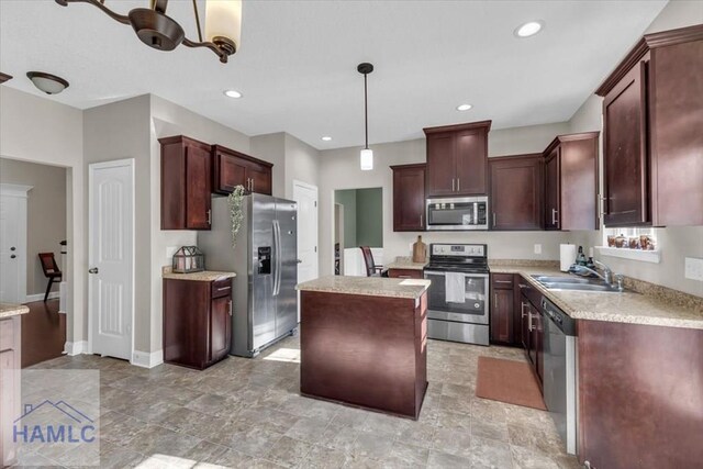 732 Waterlily Ct, Hinesville, GA 31313 - kitchen with hanging light fixtures, appliances with stainless steel finishes, light countertops, a sink, and a center island