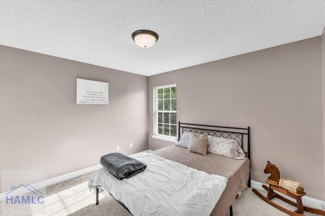 732 Waterlily Ct, Hinesville, GA 31313 - carpeted bedroom with a textured ceiling and baseboards