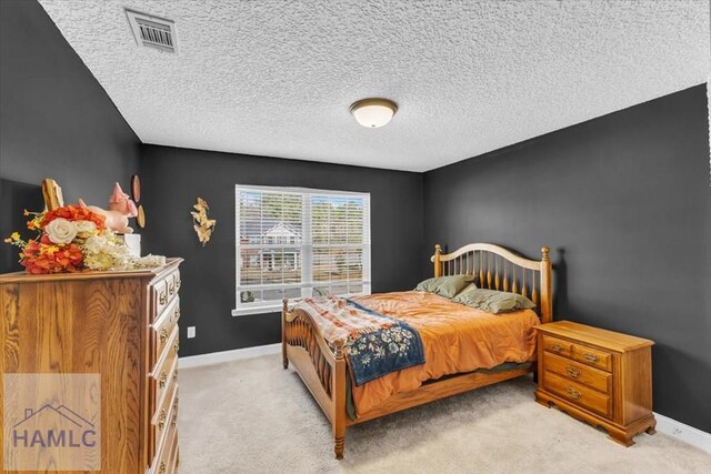 732 Waterlily Ct, Hinesville, GA 31313 - carpeted bedroom featuring a textured ceiling, visible vents, and baseboards