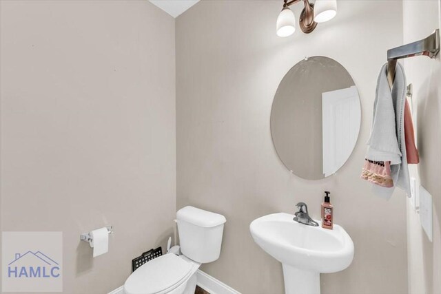 732 Waterlily Ct, Hinesville, GA 31313 - half bath with baseboards, toilet, and a sink