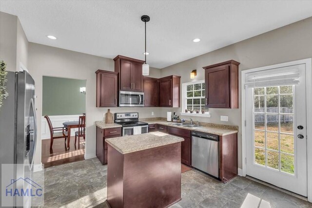 732 Waterlily Ct, Hinesville, GA 31313 - kitchen featuring a sink, appliances with stainless steel finishes, light countertops, a kitchen island, and decorative light fixtures